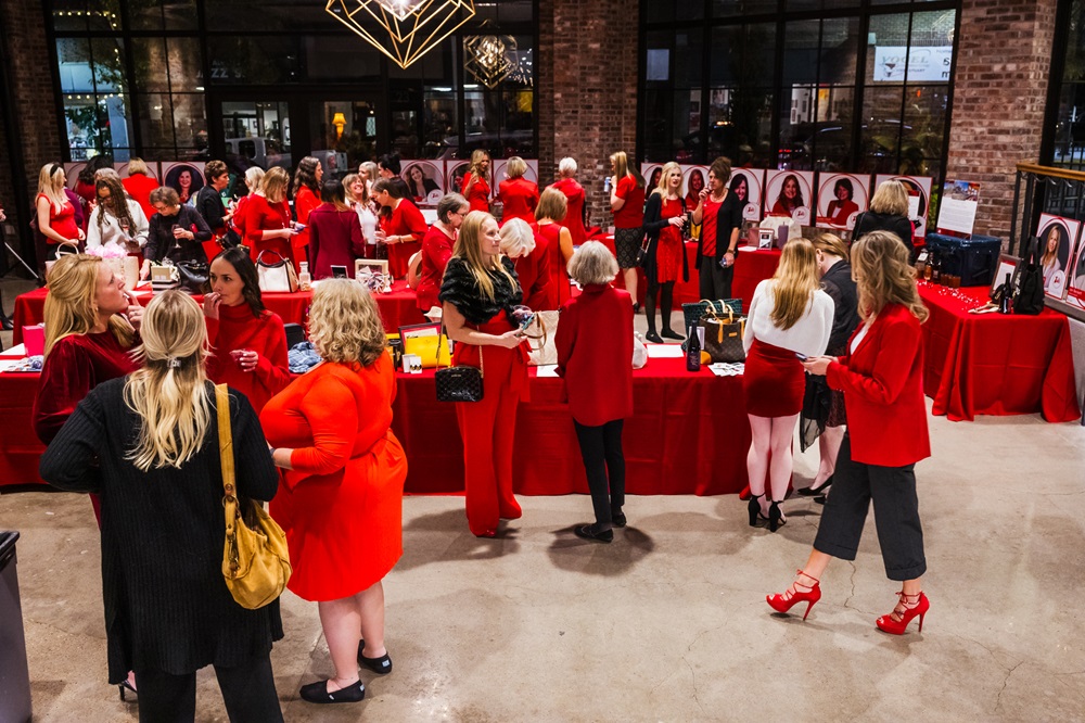 Large group of women in red among auction displays